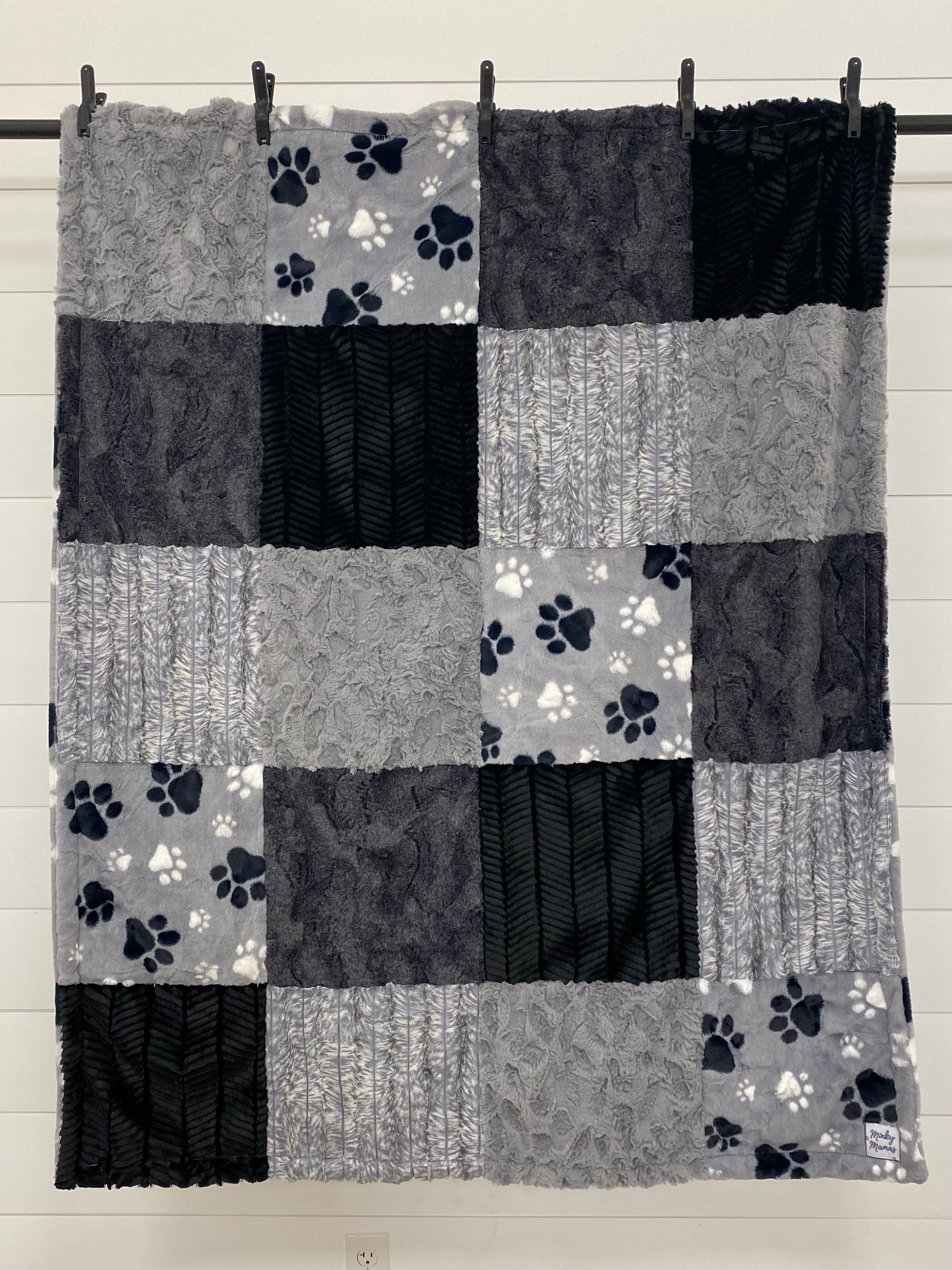 Black and Gray Throw With Paws on the Back